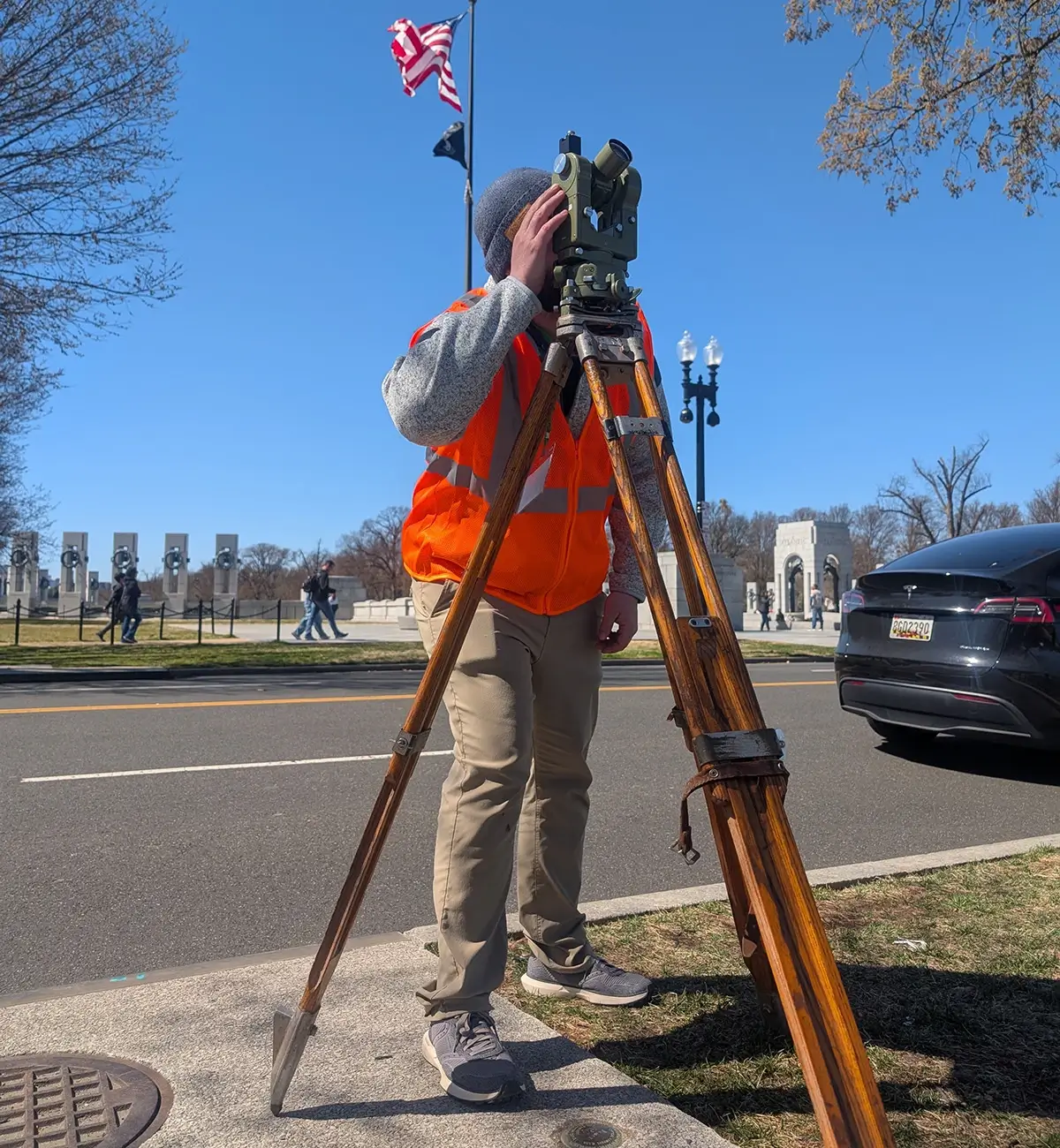 A surveyor looks through theodolite