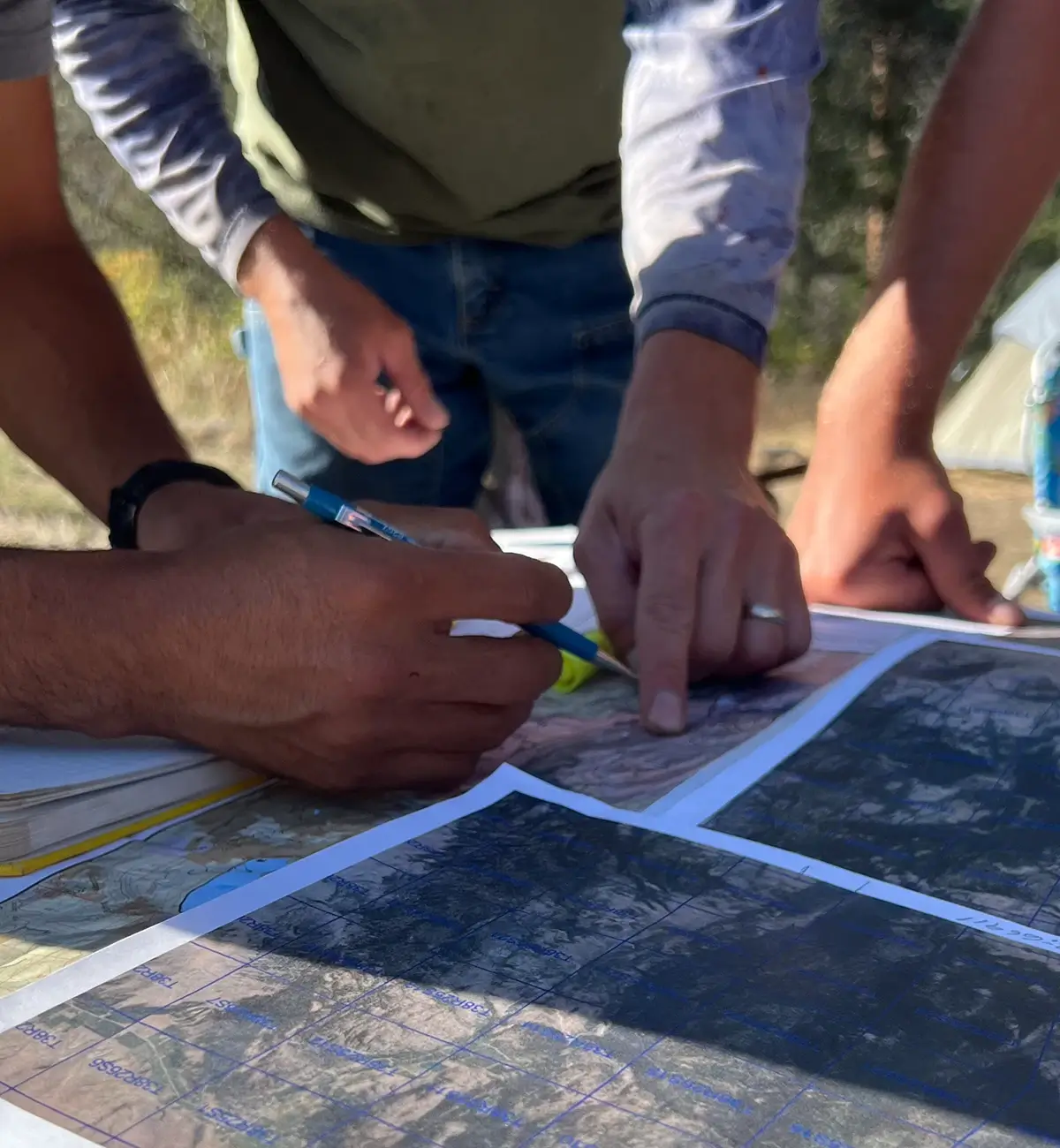 Two young surveyors map land